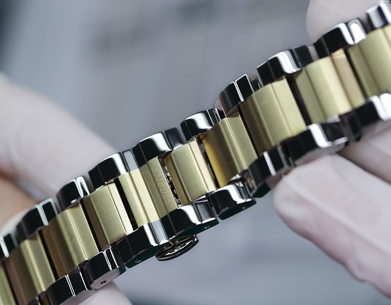 A two tone steel bracelet photographed close.
