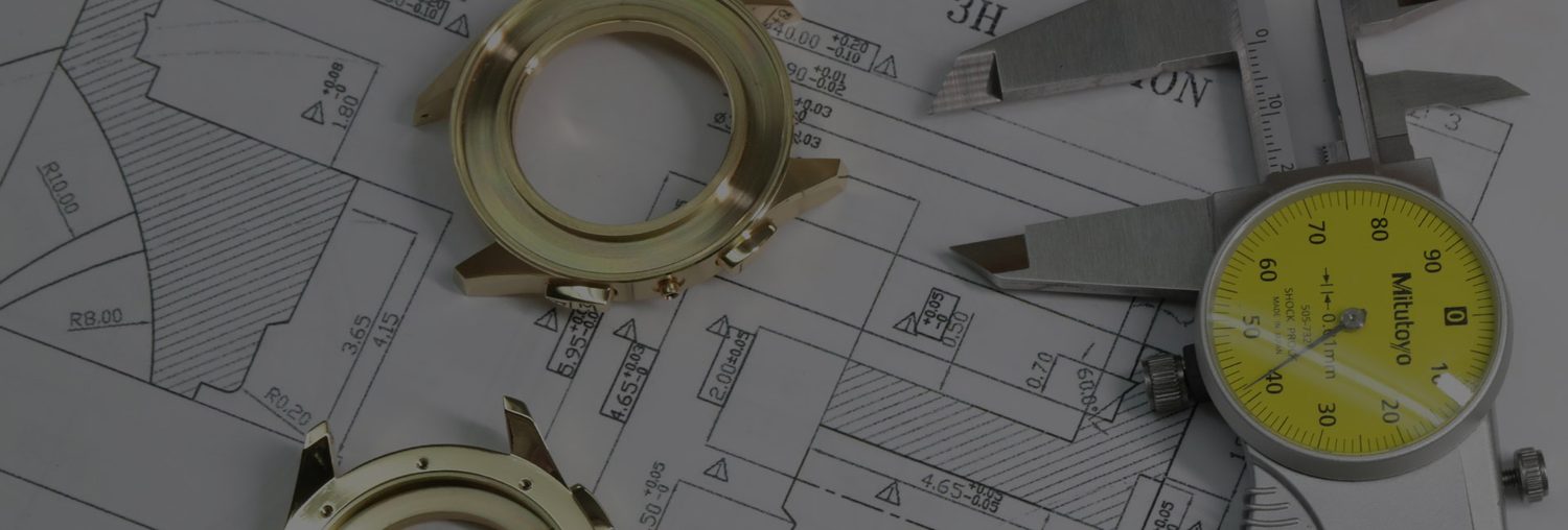 A gold watch case measured with a dial gauge on top of its own technical drawings.