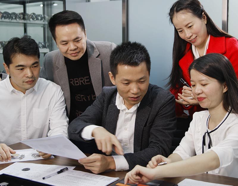 A GoTop team meeting over printed documents, published on their case studies page beside the needs exploration step.
